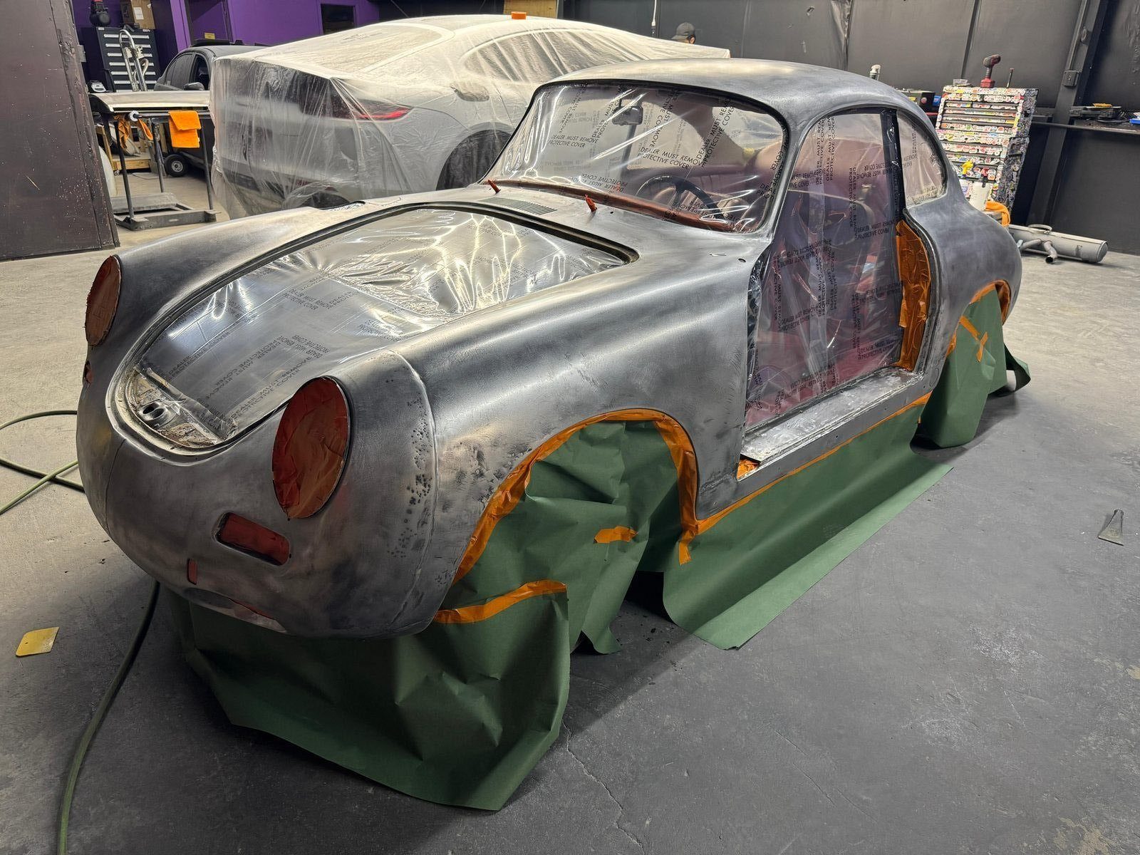 Porsche 356 SC body sanded clean to bare metal and masked off, ready for the epoxy primer coat