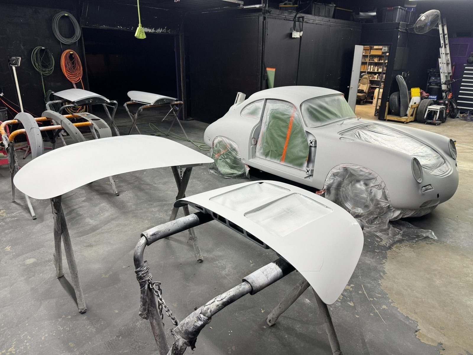 Porsche 356 SC body and detached panels coated in high-build surfacer, ready for block sanding